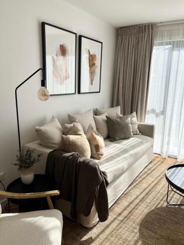 a living room with a white couch with pillows at Riverside Escape in Albert Town