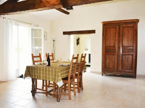 a dining room with a table and chairs and a door at G te near Saint Emilion in Saint-Martin-de-Gurçon