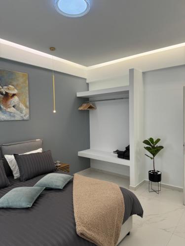 a bedroom with a bed and a potted plant at Cozy City Center Apartment in Rhodes Town