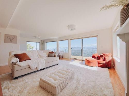 a living room with a couch and a chair at Jaw Drop View! Mt Hood! Fire Pit, Family Friendly in Underwood