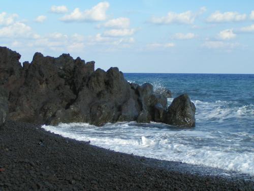 a group of rocks on a beach near the ocean at Villa Ginestra sulla spiaggia di Stromboli in Stromboli
