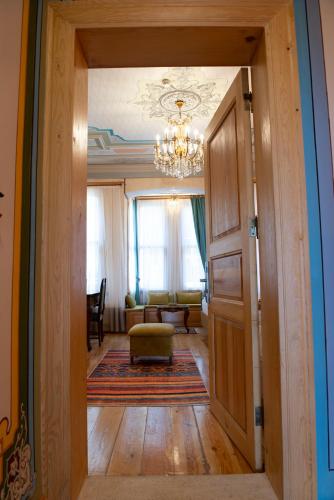 a hallway with a chandelier and a living room at İstanbul Eagle's Nest Boutique Hotel in Istanbul