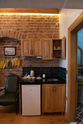 a kitchen with wooden cabinets and a brick wall at İstanbul Eagle's Nest Boutique Hotel in Istanbul