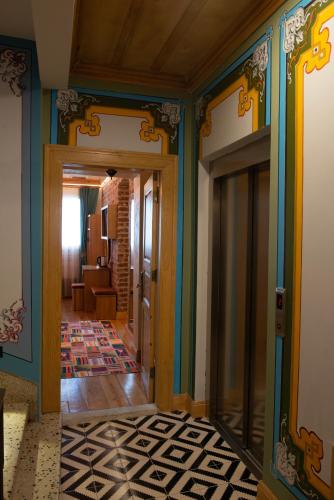 a hallway with a room with blue walls and a door at İstanbul Eagle's Nest Boutique Hotel in Istanbul