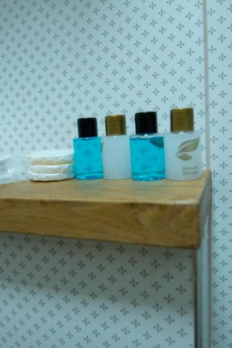a wooden shelf with five toiletries on it at İstanbul Eagle's Nest Boutique Hotel in Istanbul