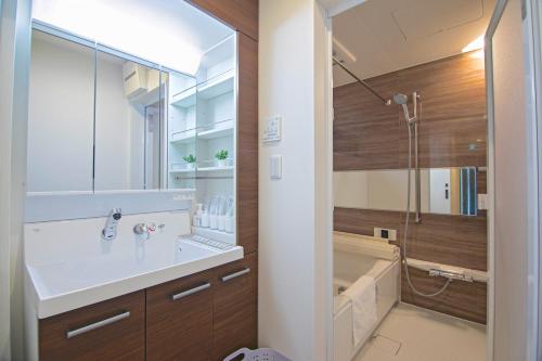 a bathroom with a sink and a shower and a tub at -旅time 小路東- Koji Higashi 車庫付き戸建 4LDK in Osaka