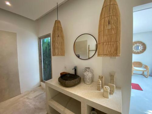 a bathroom with a sink and a mirror at Villa Mei, 2BR Pool, Seseh Beach in Dalung