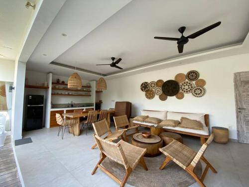 a living room with a couch and a table and chairs at Villa Mei, 2BR Pool, Seseh Beach in Dalung