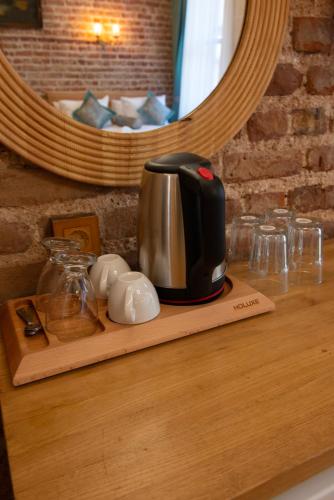 a coffee maker on a wooden tray on a counter at İstanbul Eagle's Nest Boutique Hotel in Istanbul