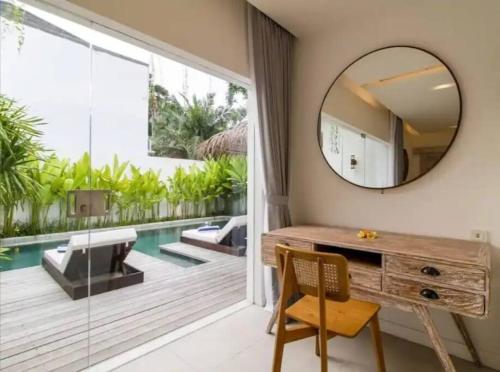 a bathroom with a vanity and a mirror and a pool at Villa Mei, 2BR Pool, Seseh Beach in Dalung