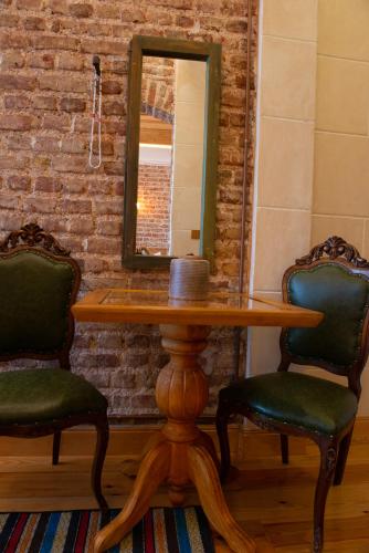 a table with two chairs and a mirror at İstanbul Eagle's Nest Boutique Hotel in Istanbul
