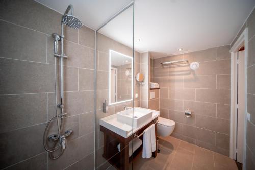 a bathroom with a sink and a shower at Maitai Express Tahiti in Papeete