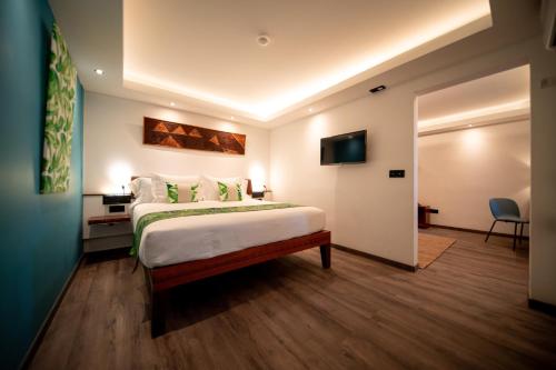 a hotel room with a bed and a television at Maitai Express Tahiti in Papeete
