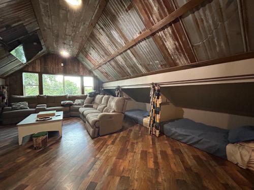a living room with a couch and a table at Bonanza Barn Retreat in Loomis