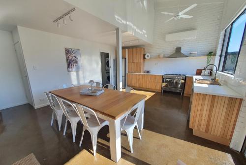 a kitchen and dining room with a wooden table and chairs at Perfect Large Multi Family Accommodation in Yarrawonga