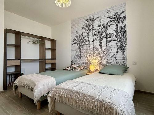 a bedroom with two beds and a wall with palm trees at Maison neuve 3 pièces calme sur Oléron proche plage et commerces - FR-1-246A-298 in Dolus d'Oléron