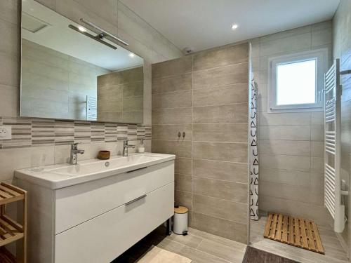 a bathroom with a sink and a mirror at Maison neuve 3 pièces calme sur Oléron proche plage et commerces - FR-1-246A-298 in Dolus d'Oléron