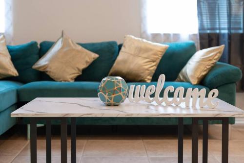 a living room with a blue couch and a coffee table at Oasis Rental in Sanford