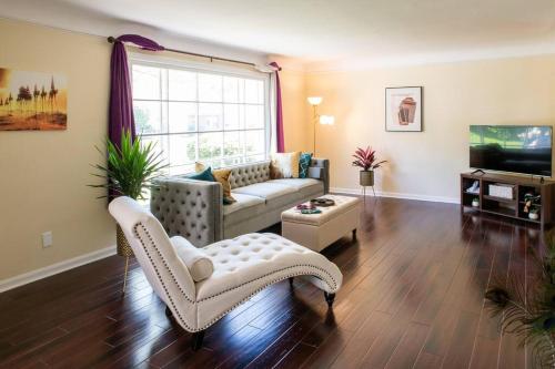 a living room with a couch and a tv at The Italian Farmhouse in Cleveland Heights
