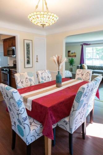 a dining room table with a red table cloth and chairs at The Italian Farmhouse in Cleveland Heights