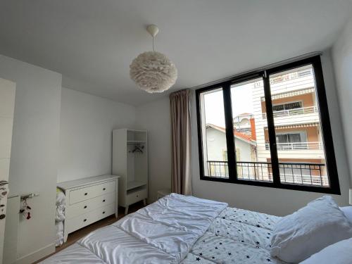 une chambre avec un lit et une fenêtre dans l'établissement Arcachon Centre : T2 avec Parking, Loggia et Proche Plage - FR-1-319-566, à Arcachon