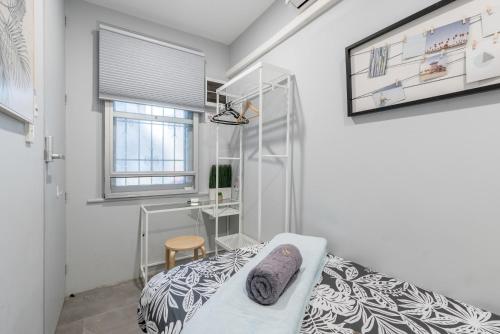 a white bedroom with a bed and a window at Modern Single Room - AC - 1Min Walk to Central- Close to Darling Harbour Chinatown CBD - Shared Bathroom in Sydney