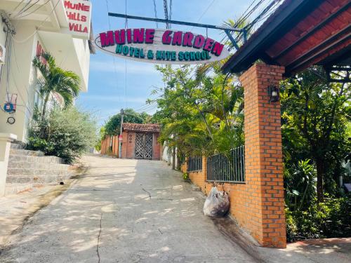 a building with a sign that reads nature chapel hotel and music school at Mui Ne Garden Hotel and Kite School in Mui Ne