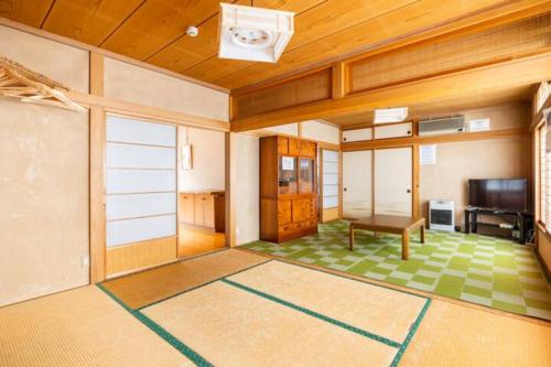a living room with a table and a television at ザホテル湯沢パラディーソ in Yuzawa