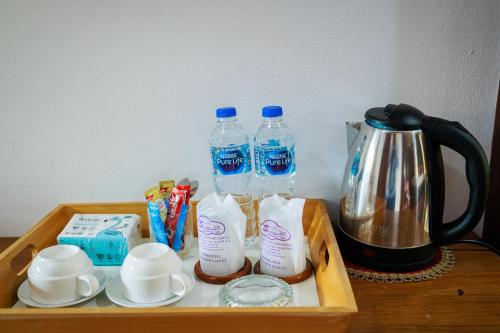 a tray with bottles of water and a coffee maker at Samui Wooden Hill Resort in Lamai