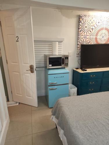a small room with a bed and a microwave at 1161 Studio 2 Miami in Tamiami