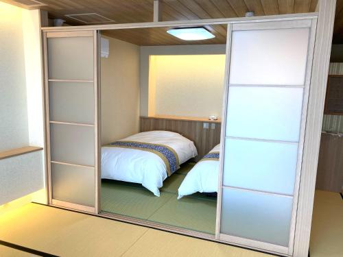 鳥取市にある観水庭 こぜにやのベッドルーム1室(クローゼット、ベッド1台付)