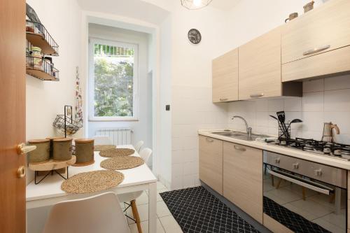 a kitchen with a table with chairs and a counter at XX SETTEMBRE 69 in Trieste