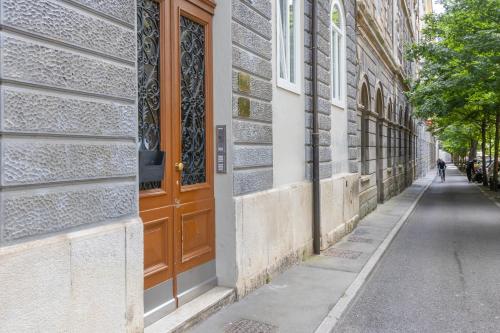 an empty street with a wooden door on a building at XX SETTEMBRE 69 in Trieste