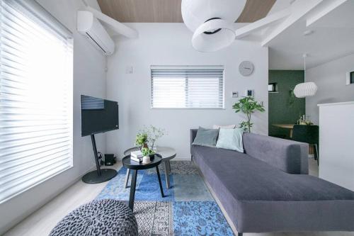 a living room with a couch and a table at ぷふか東向島3 in Tokyo