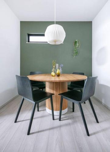 a dining room with a wooden table and chairs at ぷふか東向島3 in Tokyo