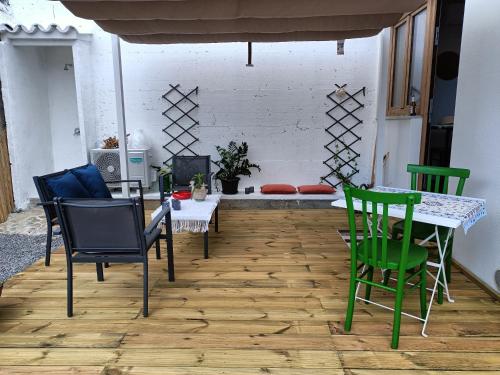 a living room with a table and chairs and a table and a couch at Rose e fiori in Teulada