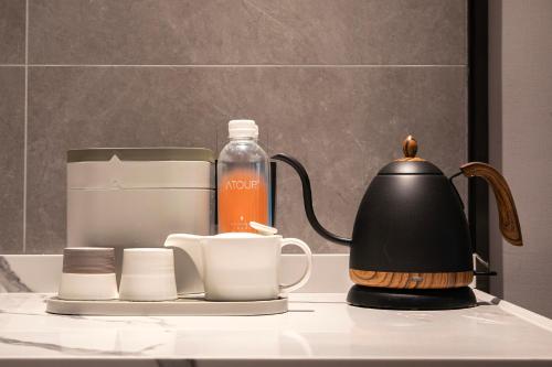 a coffee maker and a tea kettle on a table at Atour Hotel Shanghai Hongqiao Xinzhuang Business District in Shanghai