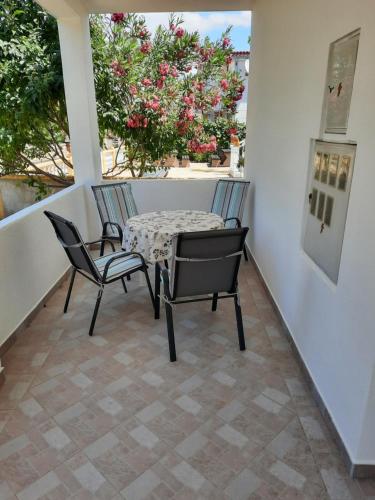 a patio with two chairs and a table on a balcony at Apartments Matkovic in Vir