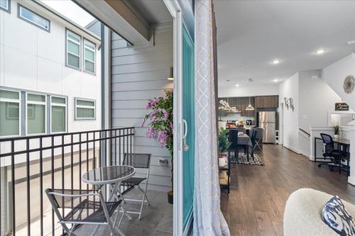 a balcony with a table and chairs in a house at 3 Bedroom Exclusive Getaway at Houston Galleria in Houston