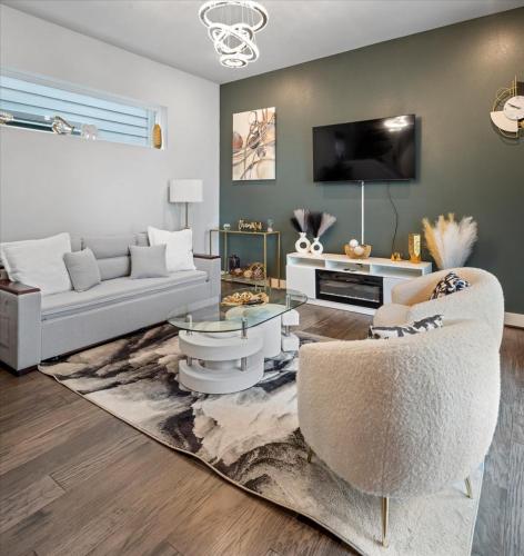 a living room with a couch and a table at 3 Bedroom Exclusive Getaway at Houston Galleria in Houston