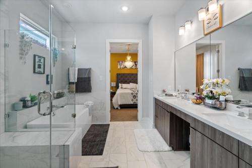 a bathroom with a tub and a sink and a shower at 3 Bedroom Exclusive Getaway at Houston Galleria in Houston