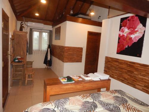 a bedroom with a bed and a desk in it at Alamanda Family Villas, Pool & Local Tours in Yogyakarta