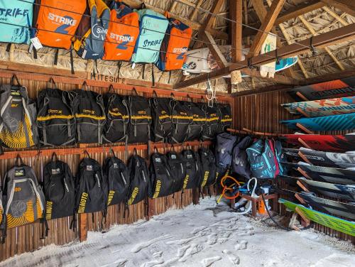 una mostra di kayak e zaini su un muro di Ocean Lodge Kite & Windsurf a Antsiranana