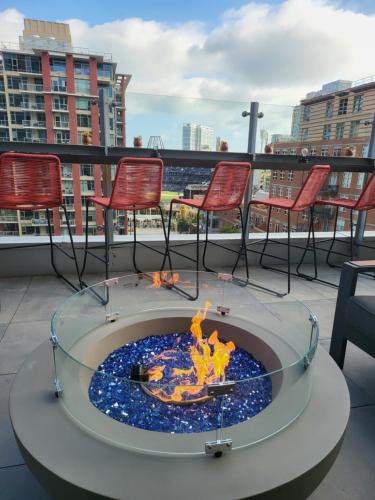 a fire pit on a balcony with chairs and tables at Hotel Indigo San Diego - Gaslamp Quarter, an IHG Hotel in San Diego