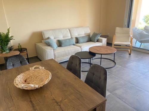 a living room with a couch and a table and chairs at Villa Vounaria in Vounaria