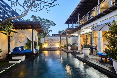 an external view of a villa with a swimming pool at Temple Hill Residence Villa in Jimbaran