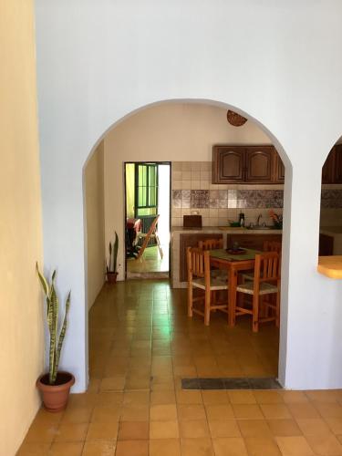 a kitchen and dining room with a table and chairs at La cueva in Tepic