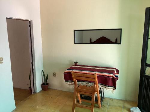 a piano in a room with a mirror on the wall at La cueva in Tepic