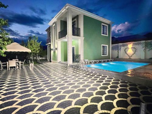 a villa with a swimming pool and a house at Luxury Villa in Ismayilli in İsmayıllı