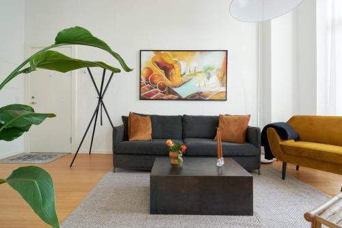 a living room with a couch and a coffee table at Top Location - Citycenter - Balcony in Copenhagen